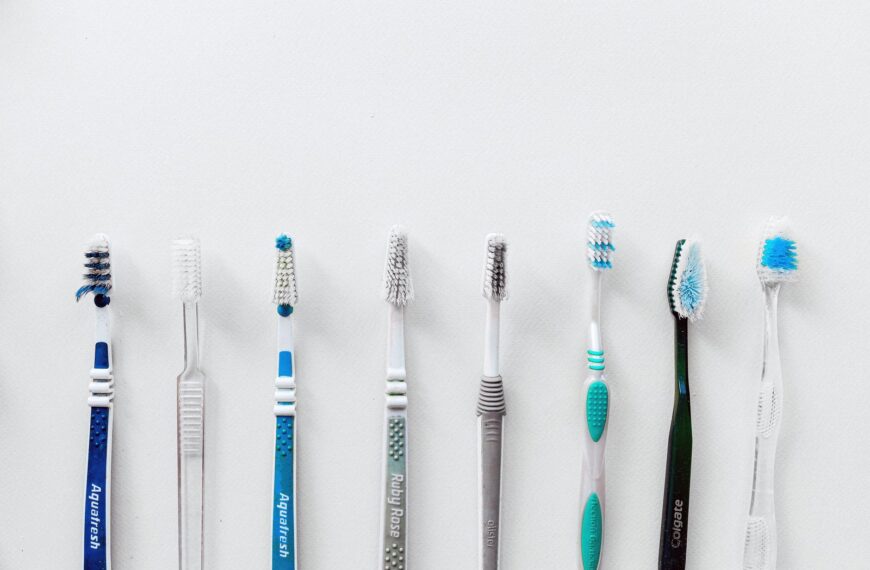 Diverse selection of toothbrushes lined up for dental hygiene focus with copy space.