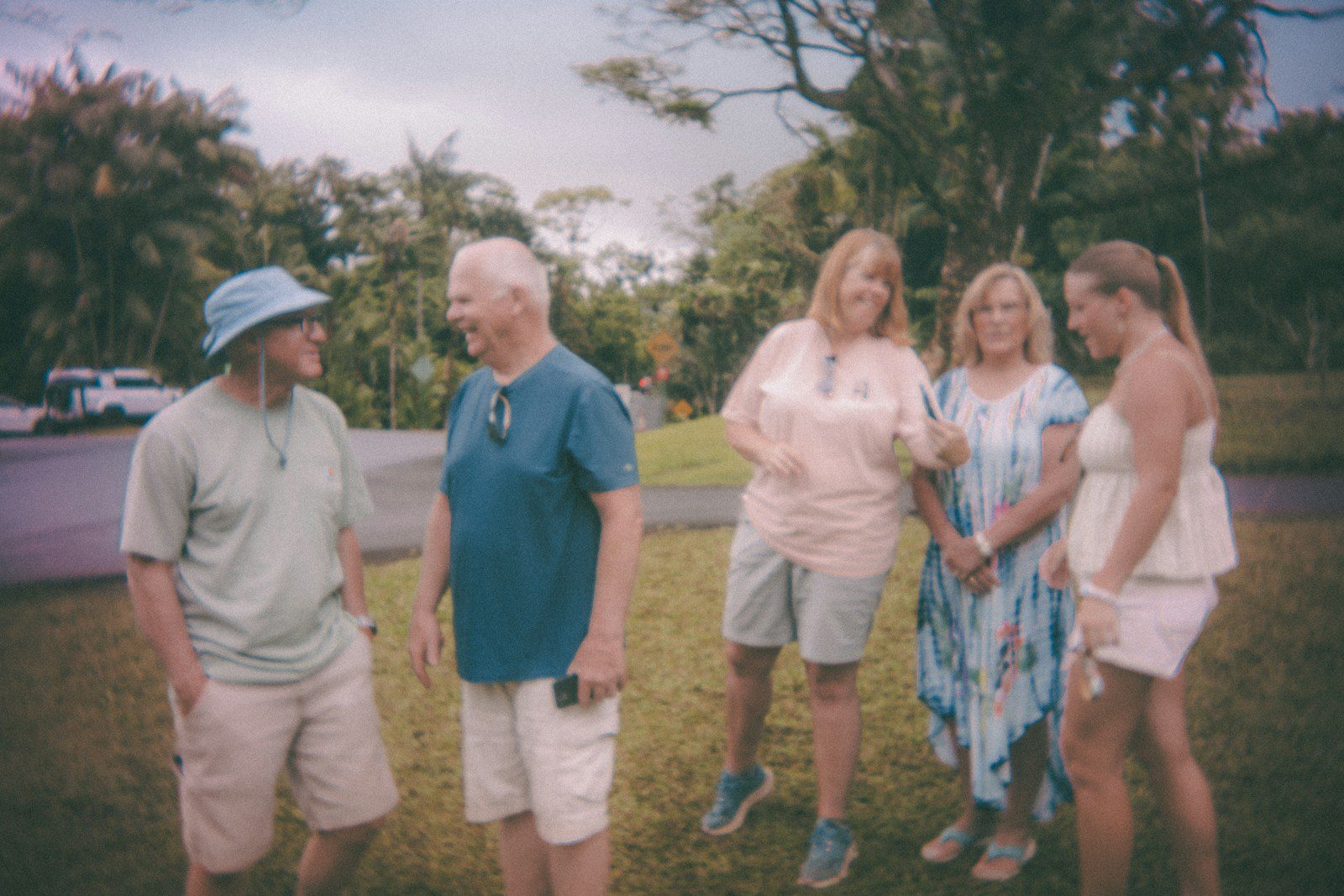 A group of five people standing on grass