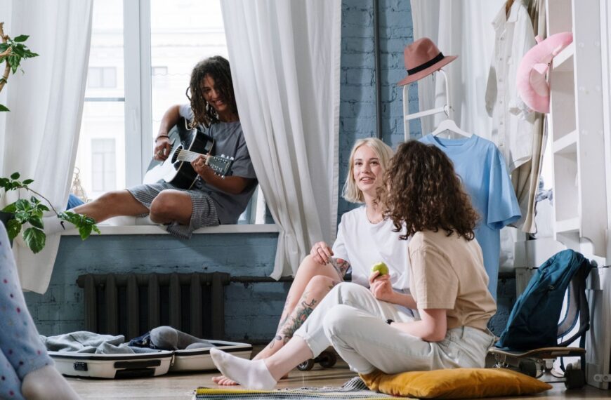 Cozy indoor scene with friends playing guitar and relaxing, capturing a sense of companionship.