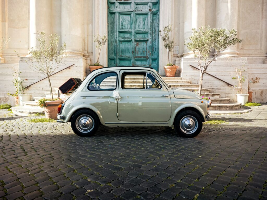 a small car parked in front of a building