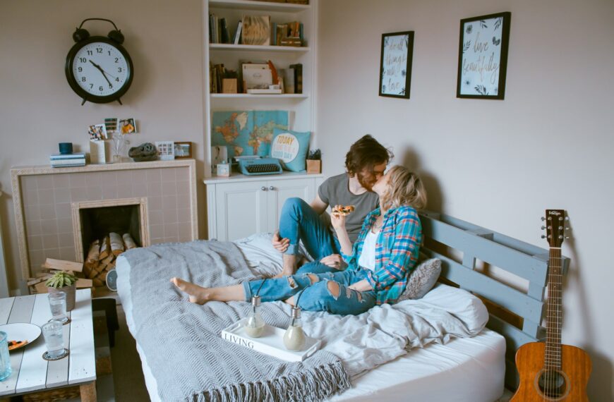 man and woman kissing on bed