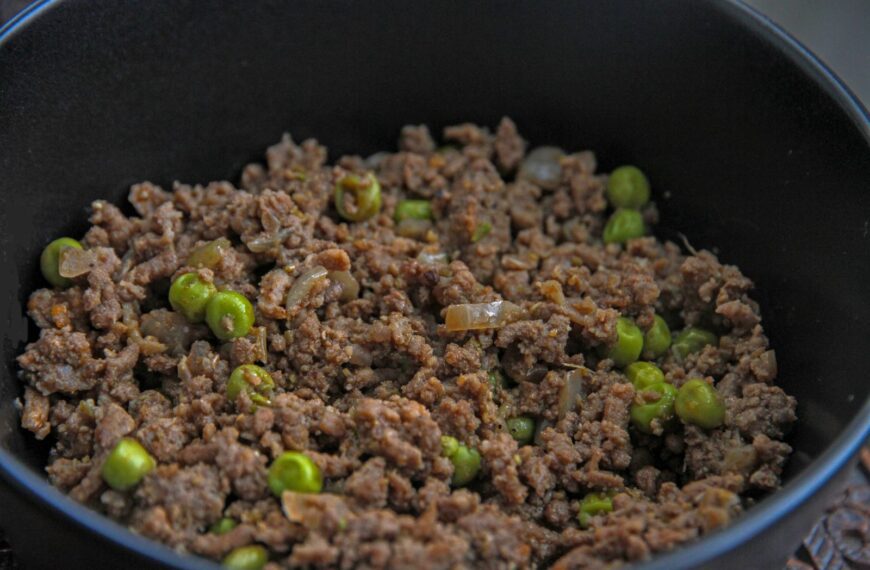 Close-up of a savory dish with minced meat and peas, ideal for culinary themes.