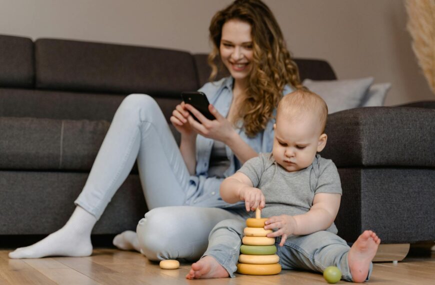 Mother and toddler engaged in playtime with toys on the floor at home.