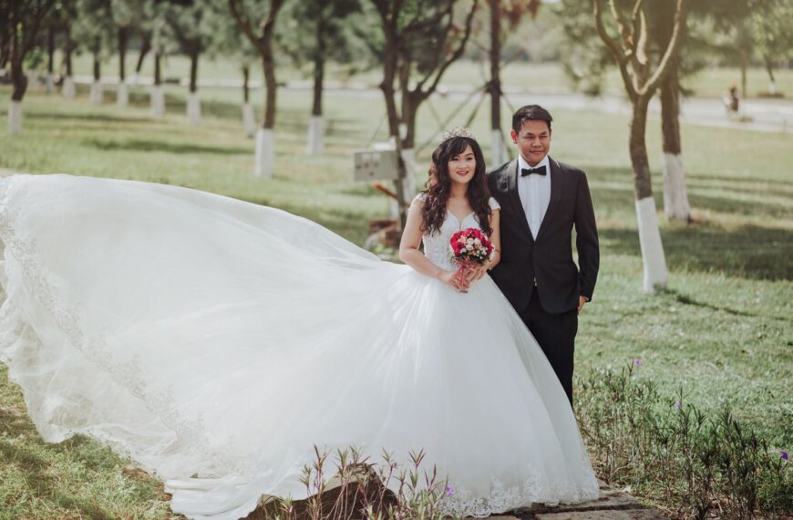 A charming outdoor wedding portrait of a smiling bride and groom on a sunny day.