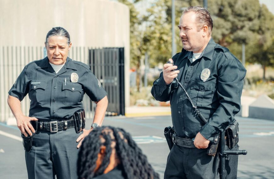 Two police officers interacting at a crime scene, focusing on communication and law enforcement duties.