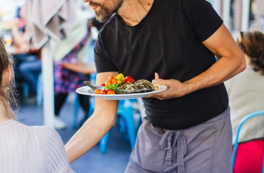man standing and holding plate
