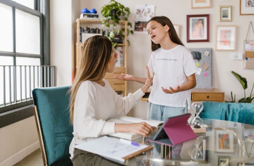 A mother and daughter engage in a meaningful conversation in a cozy home office setting.