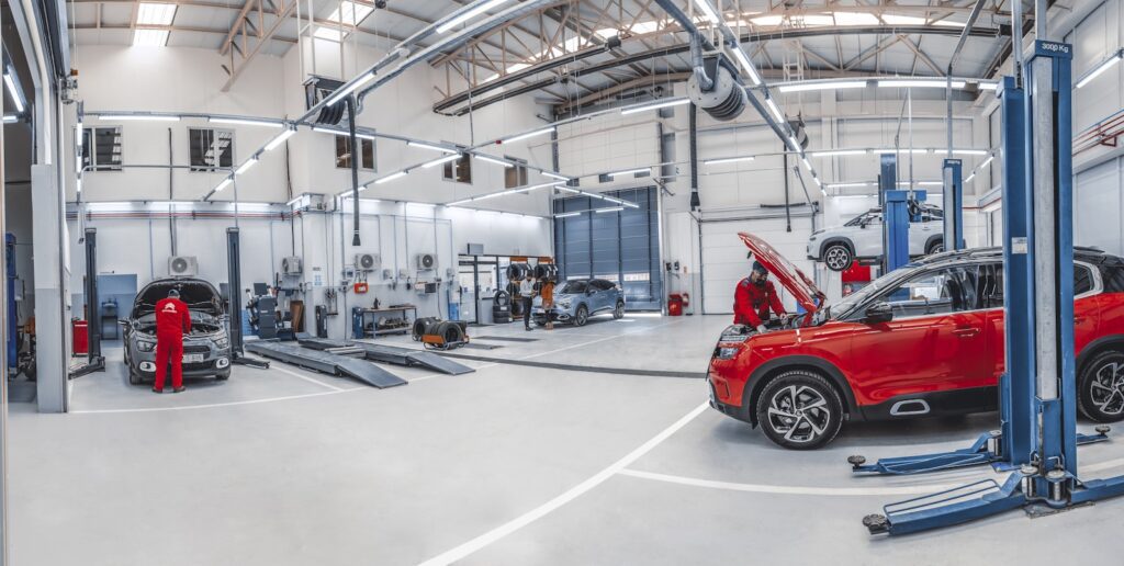 A red car is parked in a garage