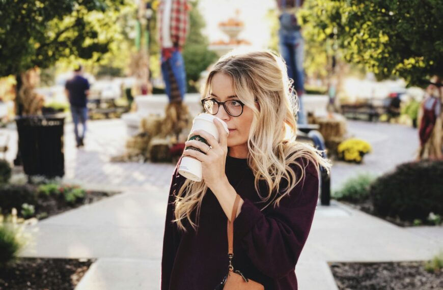 woman drinking on white cup