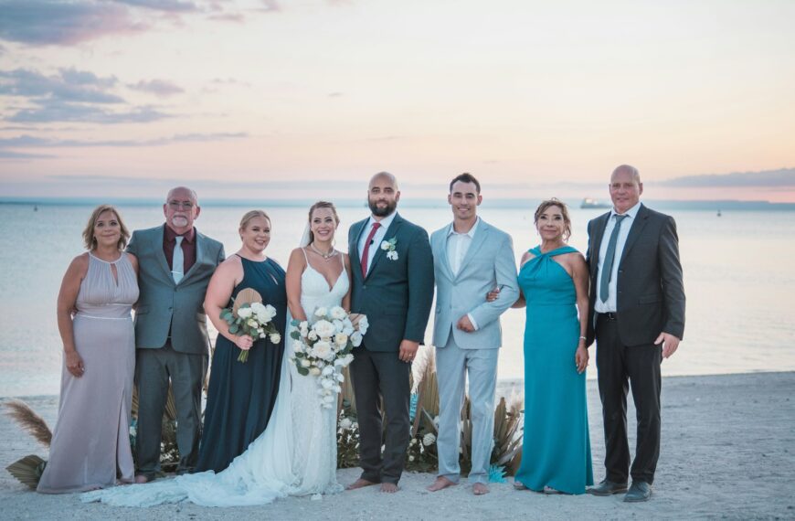 a group of people standing next to each other on a beach