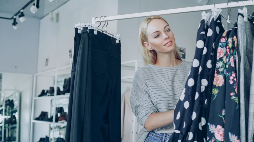 A woman shops for clothes in a boutique.
