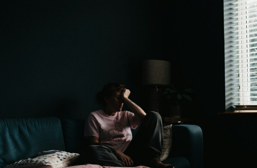 woman in purple dress sitting on couch