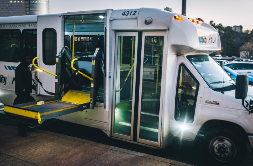 a city bus with its doors open and a ramp attached to it