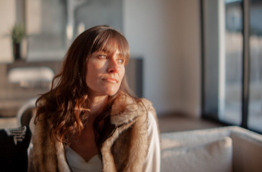 a woman sitting on a couch in a living room