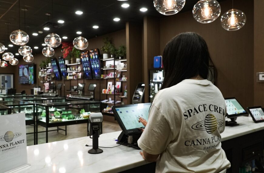 Customer uses tablet at counter in dispensary.