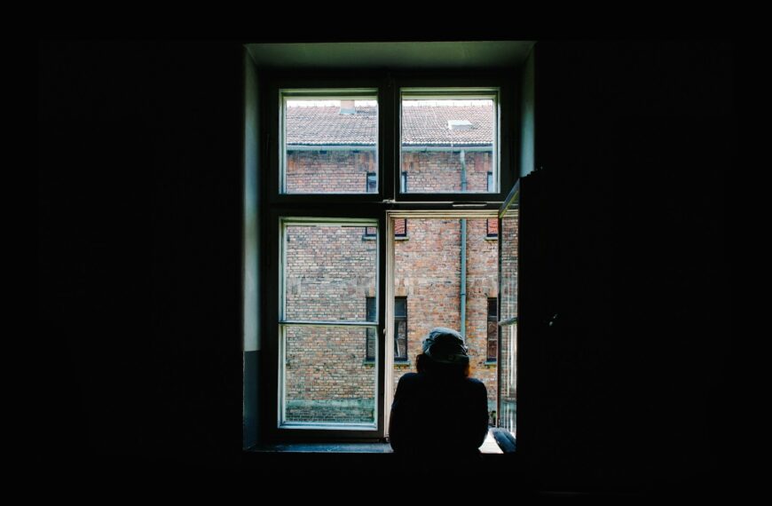 person standing in front of open window