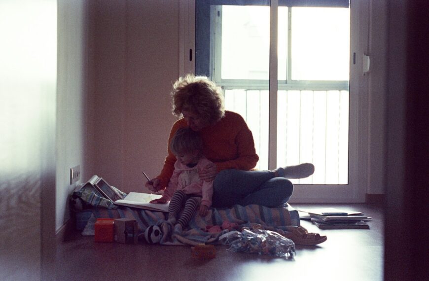 a person and a child sitting on the floor