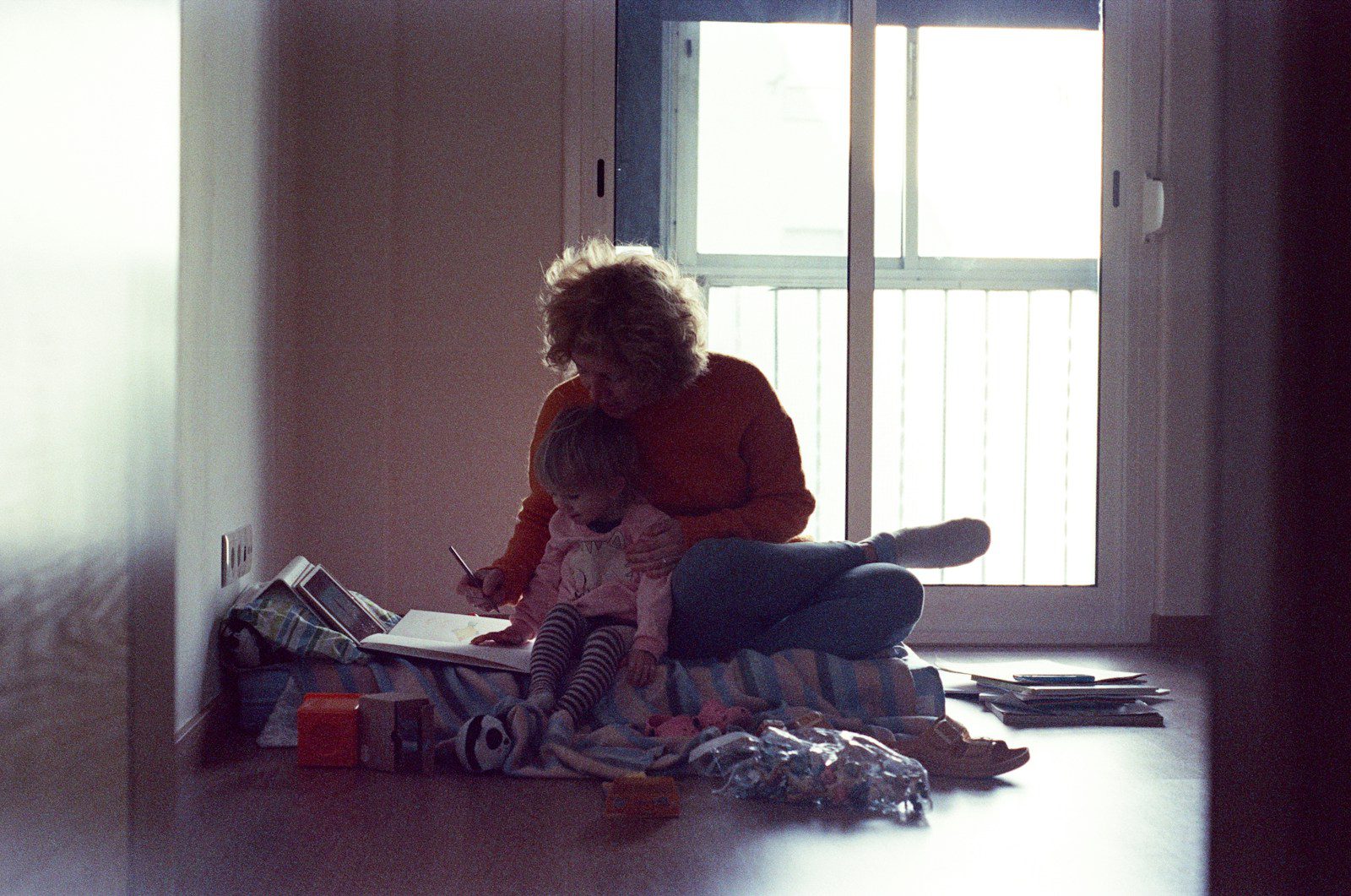 a person and a child sitting on the floor