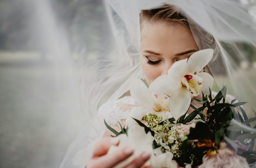 woman holding white flower bouquet