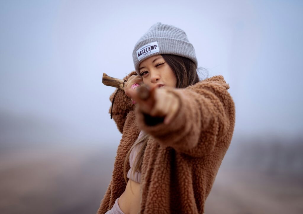 a woman wearing a hat and holding a baseball bat