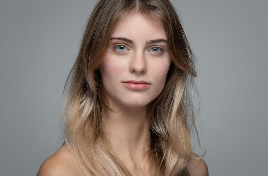 a woman with long blonde hair and blue eyes