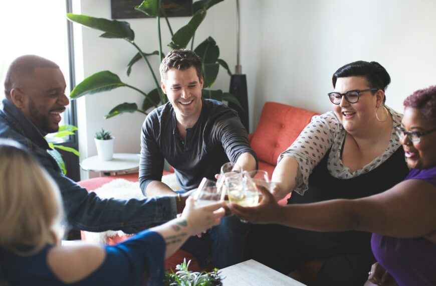 people sitting and toasting indoors