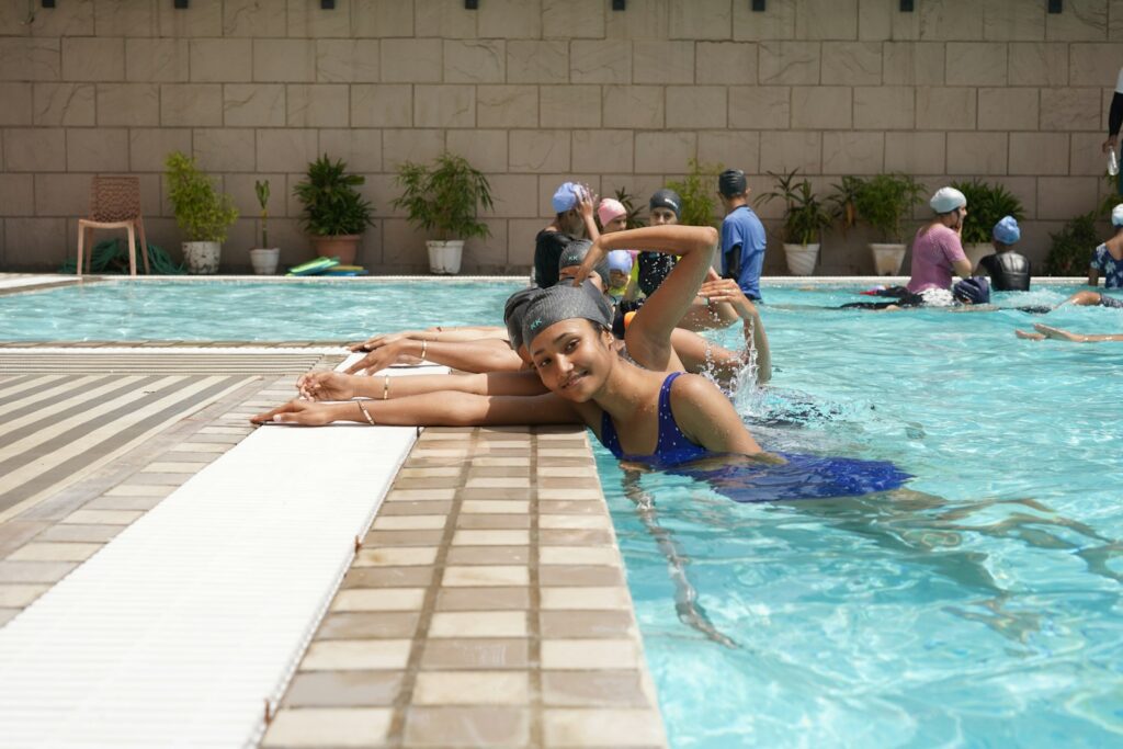 Young women swimming laps in an outdoor pool