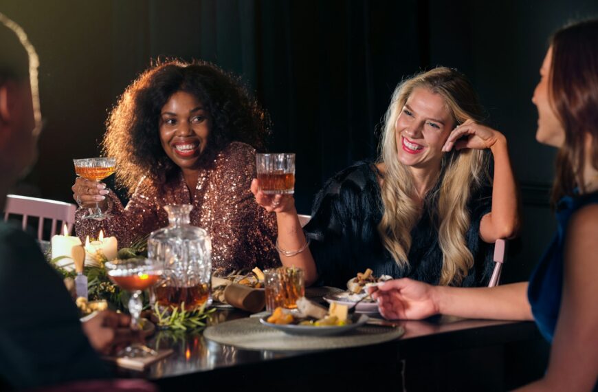 a group of people sitting around a table with food and drinks
