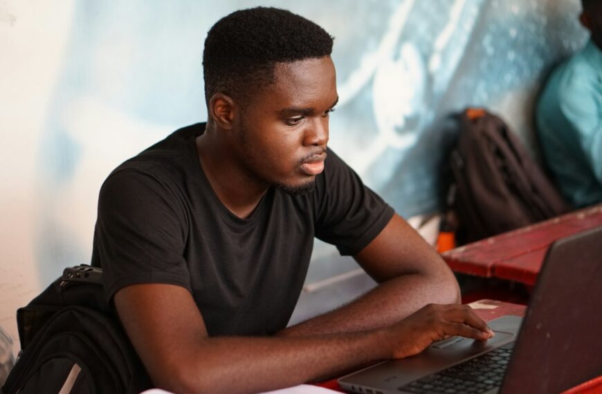 man in gray crew neck t-shirt using laptop computer