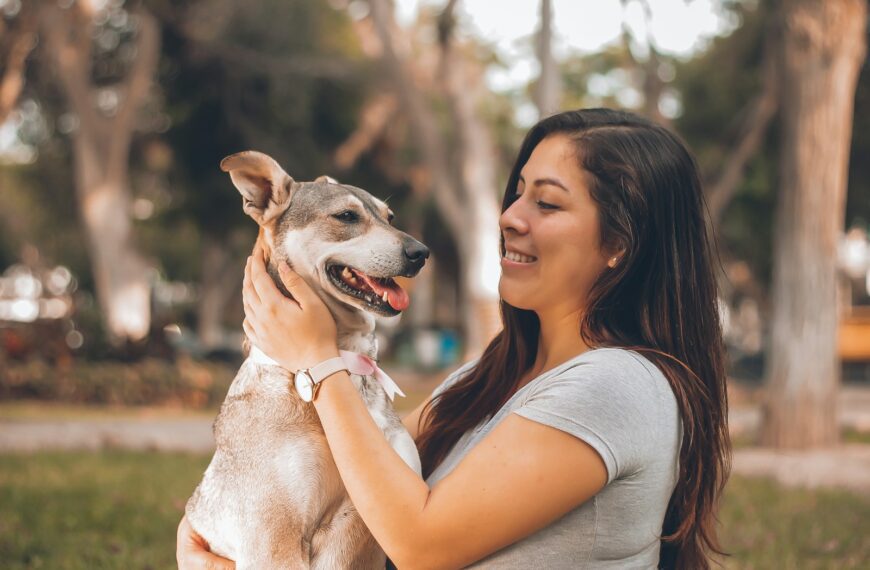 woman playing with dog