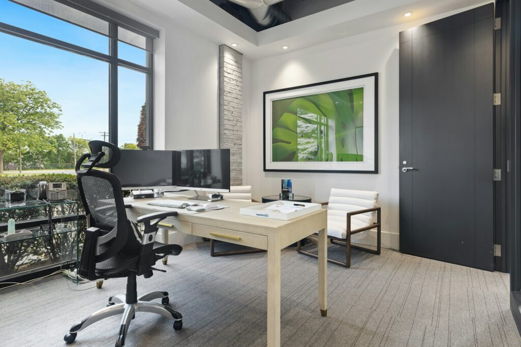 a room with a desk and chairs