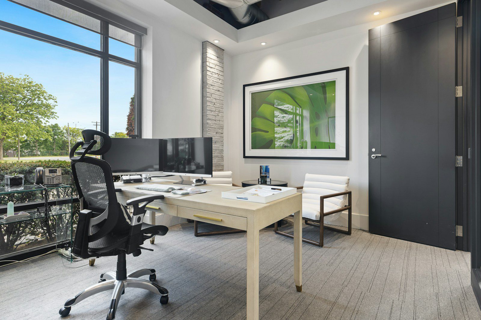 a room with a desk and chairs