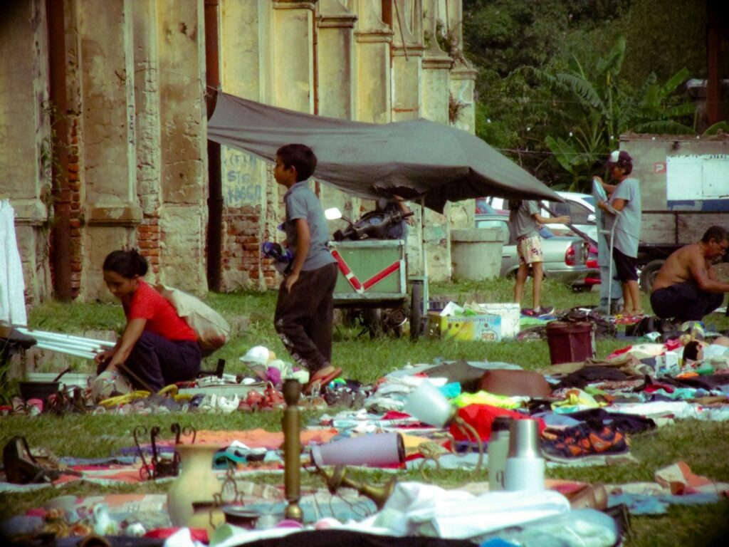 People gathered around items spread on grass