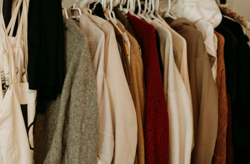 brown and white coat hanged on rack