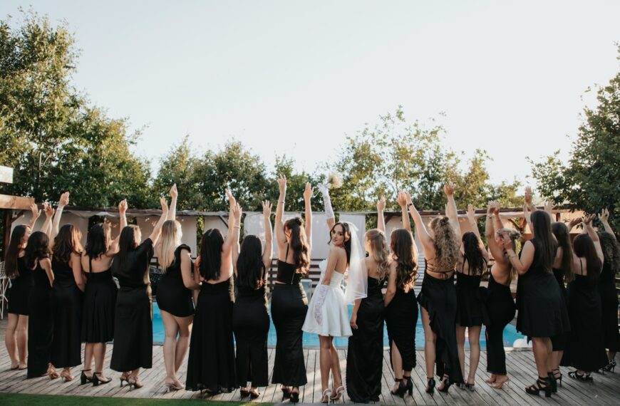 Bride and bridesmaids celebrating with raised arms