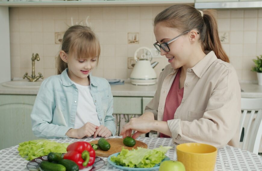 Mother and daughter preparing food in the kitchen.