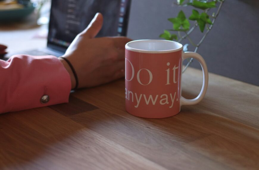 pink and white ceramic mug on table