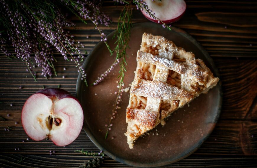 Slice of apple pie with fresh apples and lavender