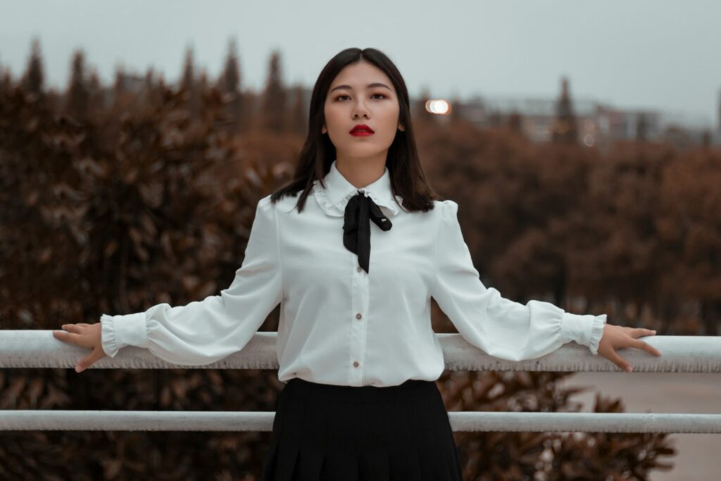 a woman wearing a white shirt and black skirt