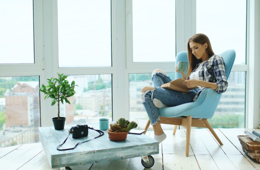 Woman reading a book in a modern armchair.
