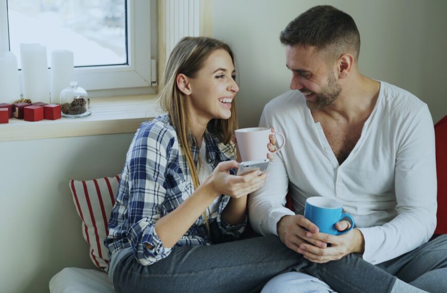 Couple enjoying coffee together by the window