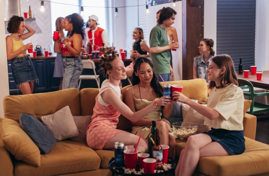 A vibrant indoor party scene with friends enjoying drinks and snacks, creating a fun atmosphere.
