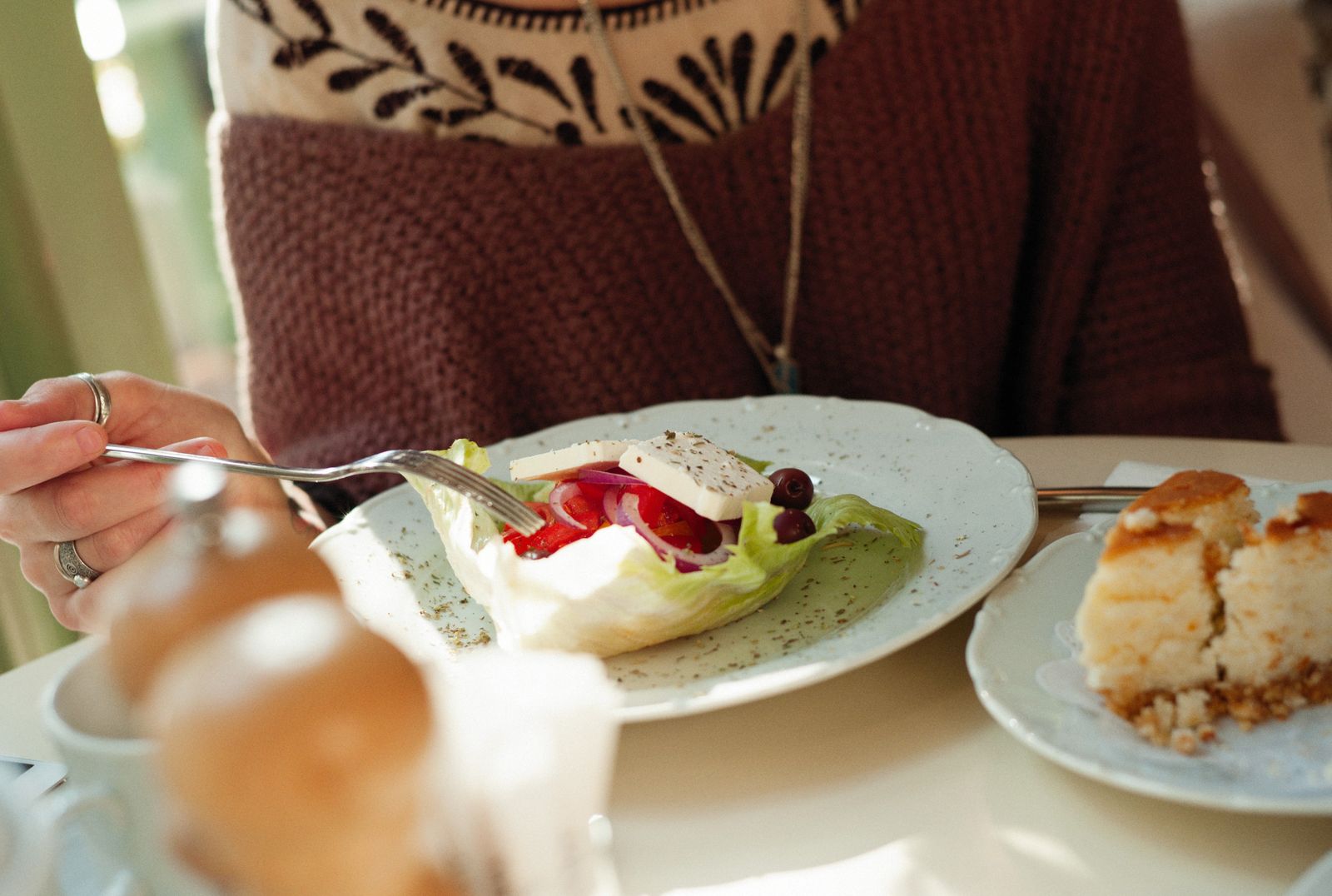 A cozy cafe scene with a fresh salad and dessert. Perfect for culinary themes.