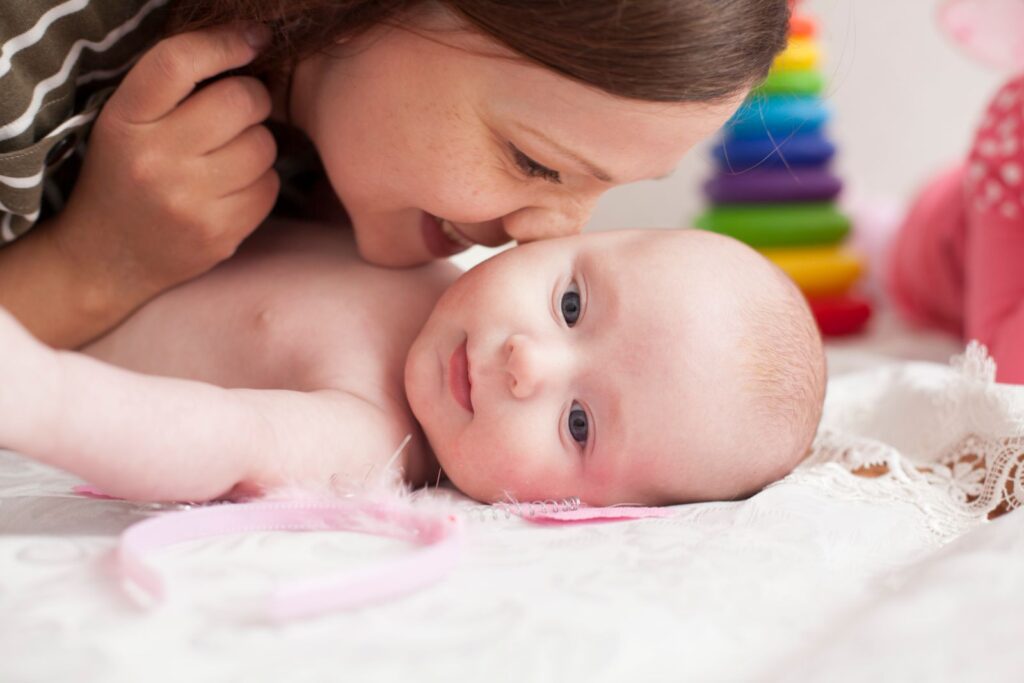 Tender moment between mother and baby with a warm and cozy atmosphere.