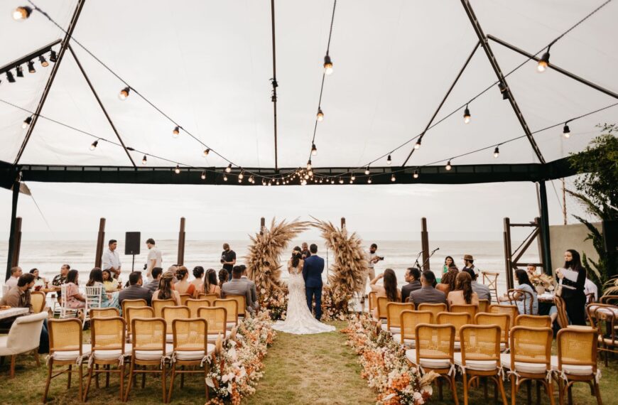 A picturesque wedding ceremony held outdoors under a canopy by the sea. Perfect setting for a romantic event.