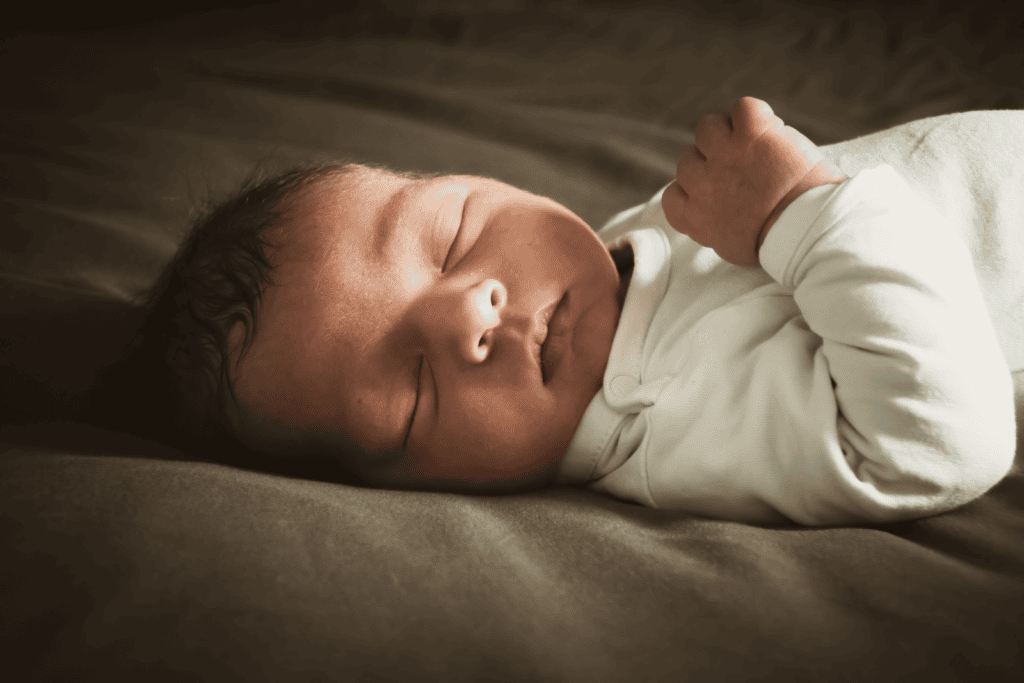 Close-up of a newborn sleeping peacefully indoors with soft lighting. Ideal for lifestyle and family themes.