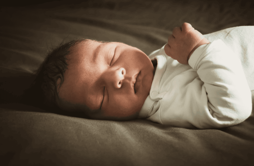 Close-up of a newborn sleeping peacefully indoors with soft lighting. Ideal for lifestyle and family themes.