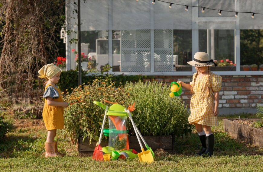 Two young girls enjoying a summer day gardening with toy tools. A perfect blend of fun and learning outdoors.