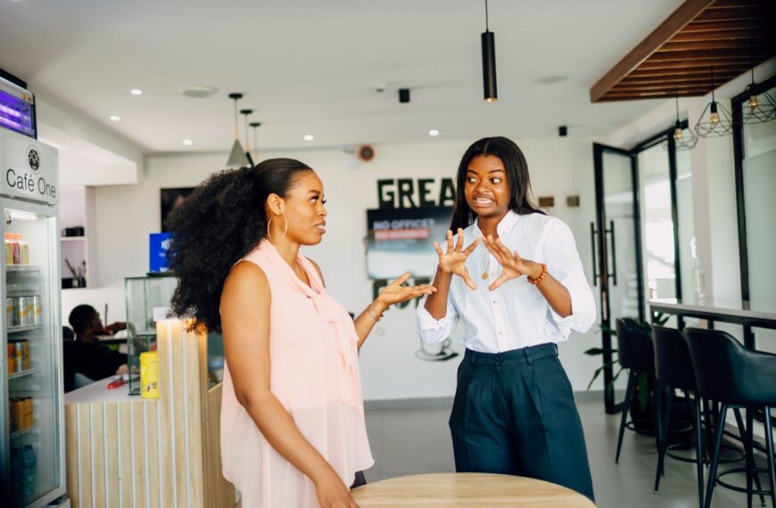 Two women engaging in a vibrant discussion at Café One in Lagos, Nigeria.