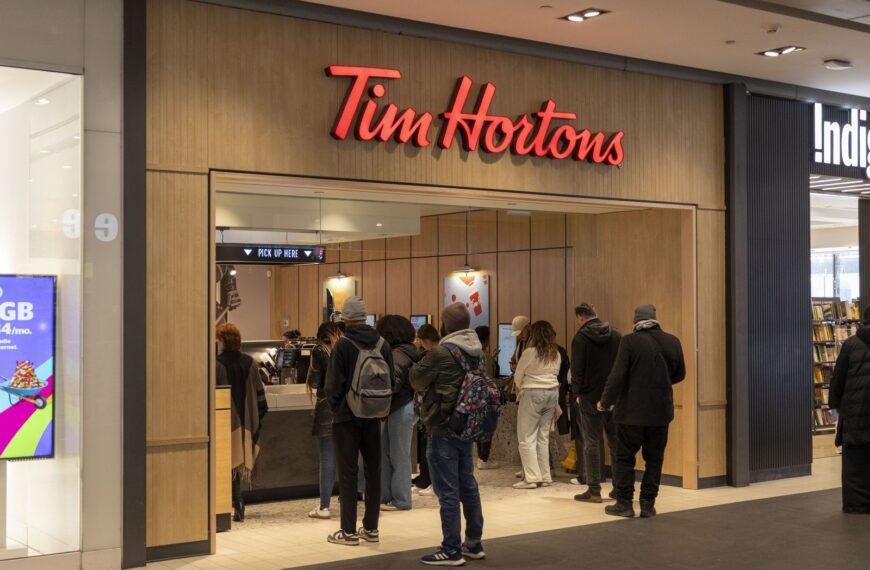 Busy Tim Hortons with customers waiting in line at the counter.
